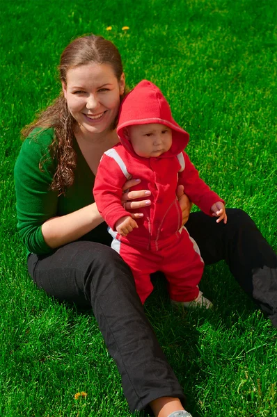 Женщина и ее ребенок на зеленой траве — стоковое фото