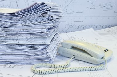 White phone and heap of project drawings clipart