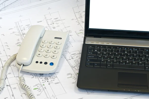 Laptop, phone on project drawings — Stock Photo, Image