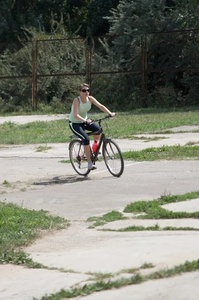 Νεαρή γυναίκα ιππασίας το ποδήλατο — Φωτογραφία Αρχείου
