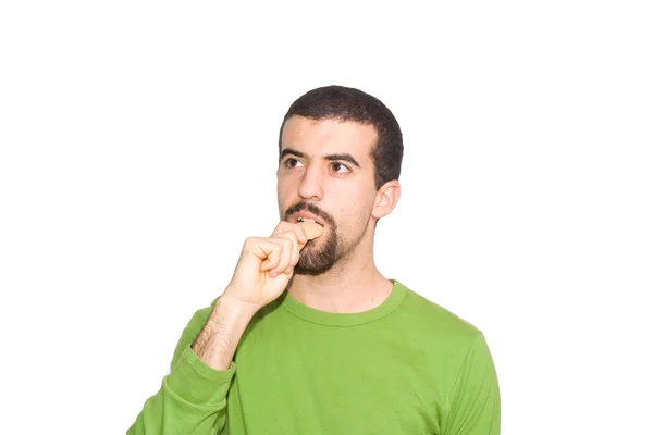 Homem comendo um biscoito doce — Fotografia de Stock