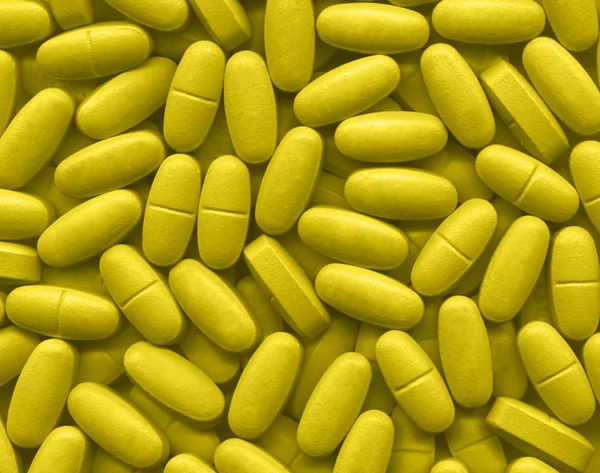 Yellow pills texture — Stock Photo, Image