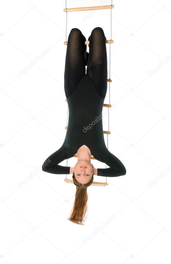 Woman hanging on a rope ladder