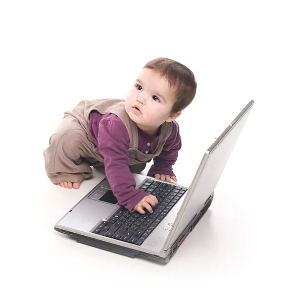 Baby girl with a laptop — Zdjęcie stockowe