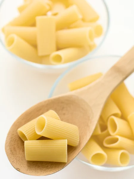 Raw pasta in glass bowl — Stock Photo, Image