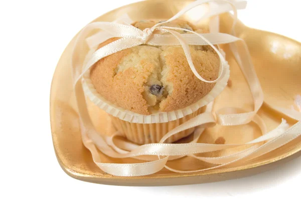 Muffin on a gold plate — Stock Photo, Image
