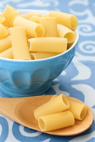 Raw pasta in a blue bowl — Stock Photo, Image