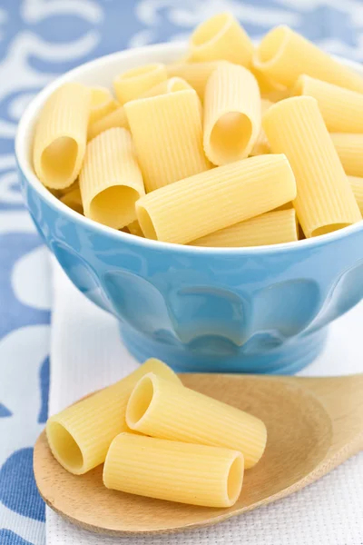 Raw pasta in a blue bowl — Stock Photo, Image