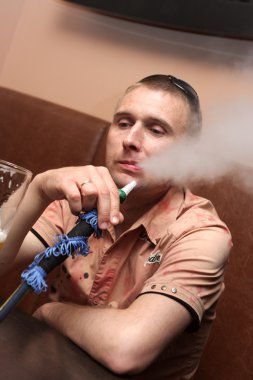 Man in shisha house clipart