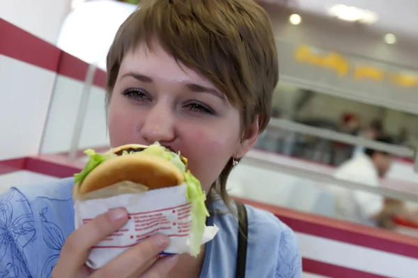 Woman bites burger