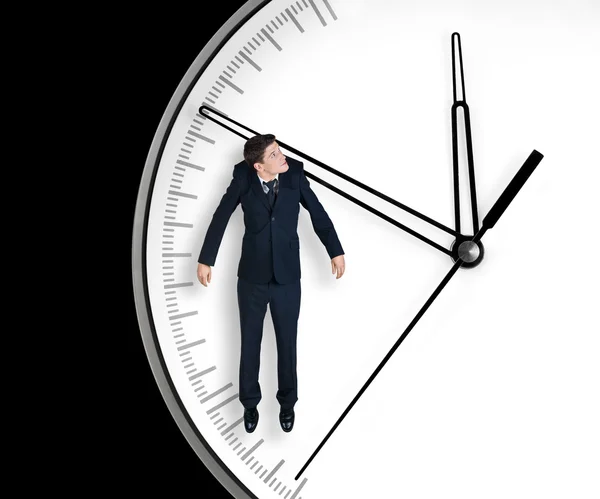 Biznesmen wisi na strzałce zegara — Zdjęcie stockowe