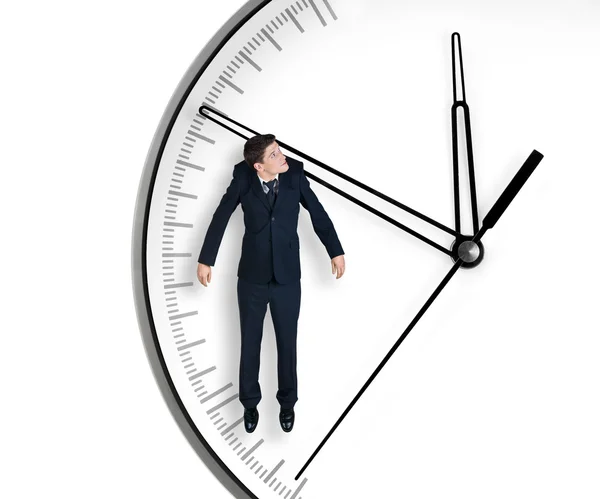 Biznesmen wisi na strzałce zegara — Zdjęcie stockowe
