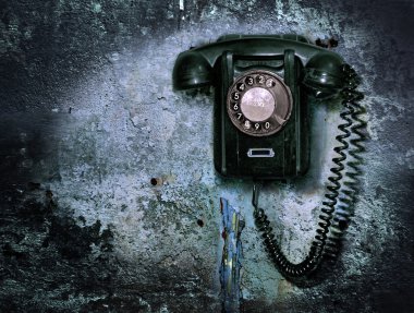 Old phone on the destroyed wall clipart