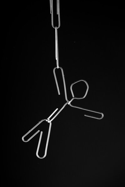 A paper clip man hanging