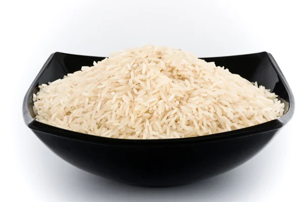Grãos de arroz não cozidos em tigela — Fotografia de Stock