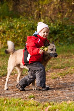 Little girl playing with her dog clipart