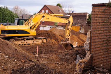 Excavator at demolition site clipart