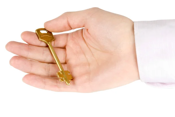 Золотой ключ в руке — стоковое фото
