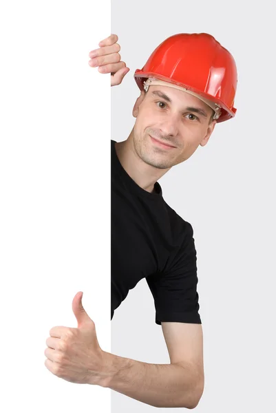Trabalhador da construção com um sinal em branco — Fotografia de Stock