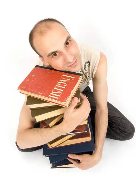 Šťastný mladý muž s knihami — Stock fotografie