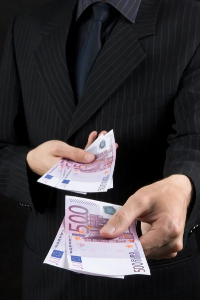 Businessman holding euros — Zdjęcie stockowe