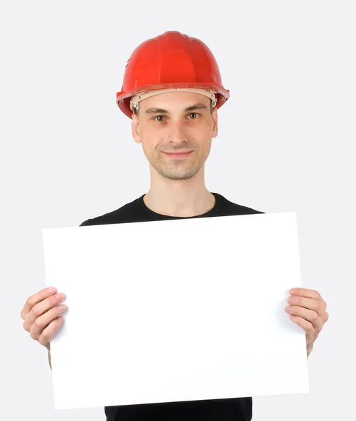 Trabalhador da construção com um sinal em branco — Fotografia de Stock