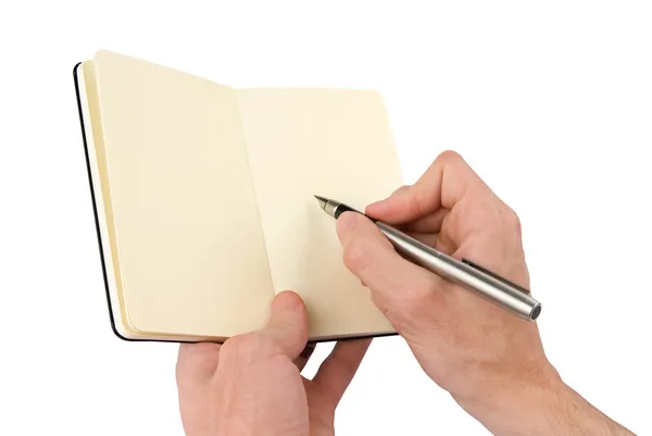 Person writing in notebook Stock Photo
