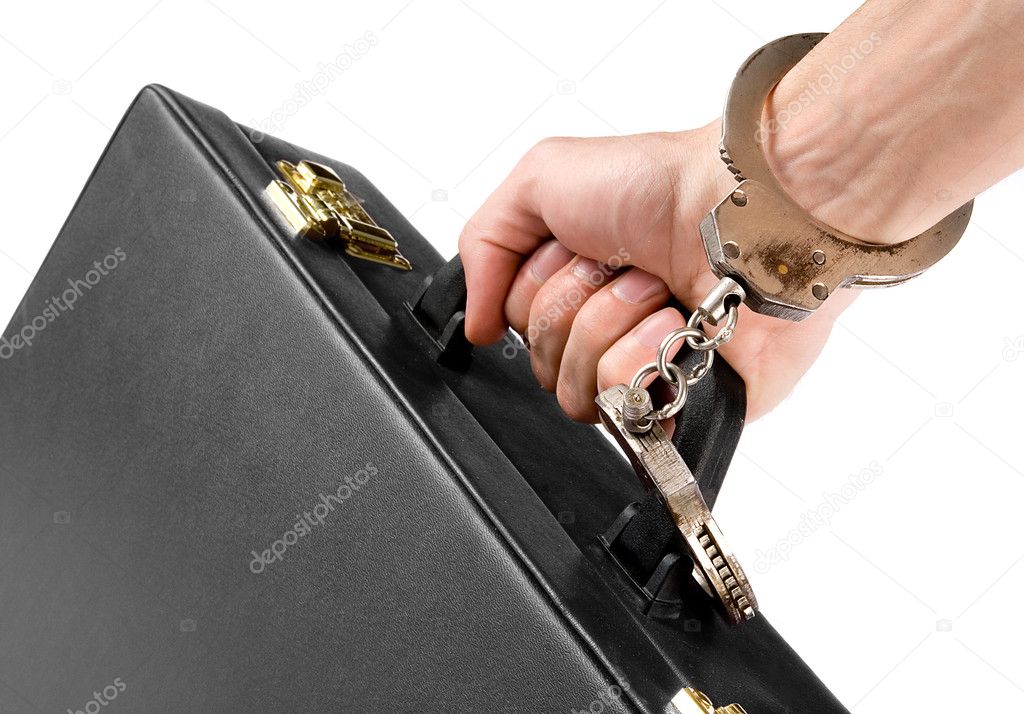 Hand on handcuffs with a briefcase