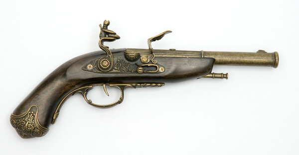 Old flintlock pistol isolated on white b