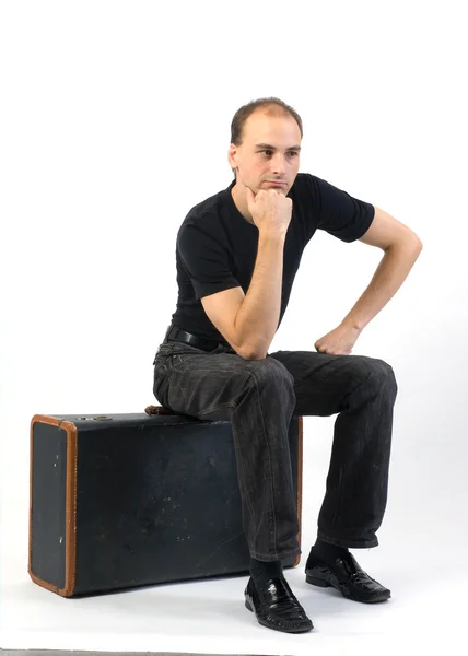 Homme assis sur une valise — Photo
