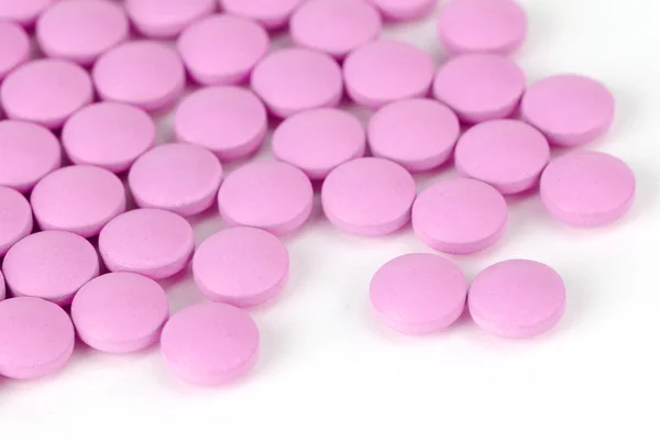 Eine Handvoll rosa Tabletten — Stockfoto