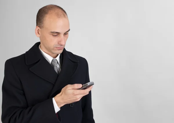 Businessman holding a mobile phone — Stock Photo, Image