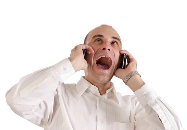 Businessman screaming at telephones — Stock Photo, Image