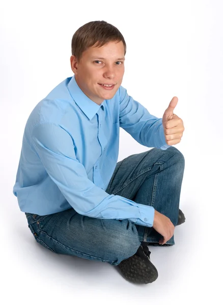 Pohledný mladý muž s palec nahoru — Stock fotografie