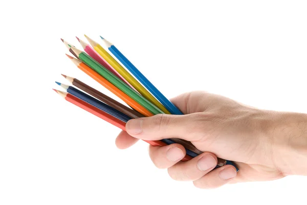 Hands with colored pencils over white — Stock Photo, Image
