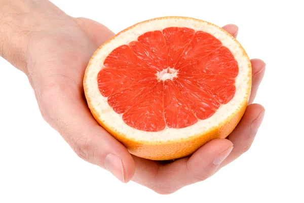 Mänskliga handen håller en halv grapefrukt — Stockfoto