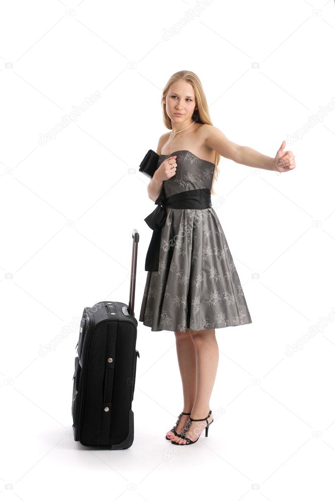 Young woman hitch hiking with suitcase