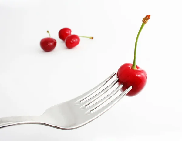 Ripe sweet cherries on fork — Stock Photo, Image