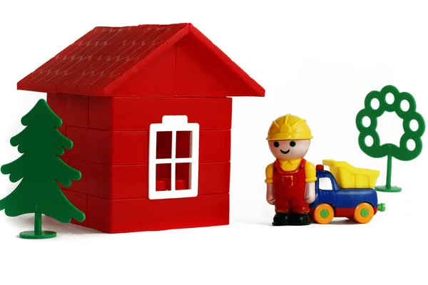 Little builder and toy house — Stock Photo, Image