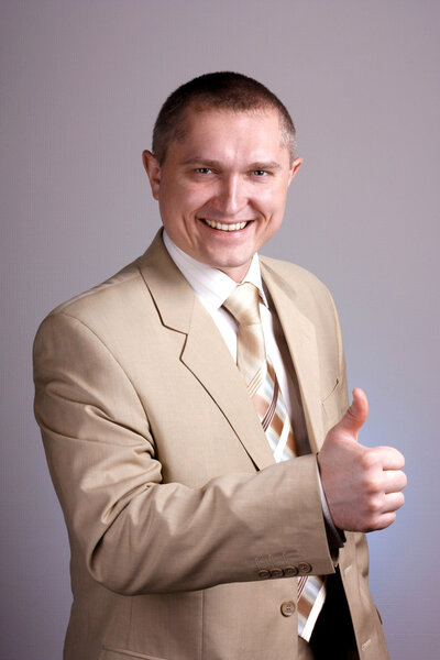 Positive business man with thumbs up