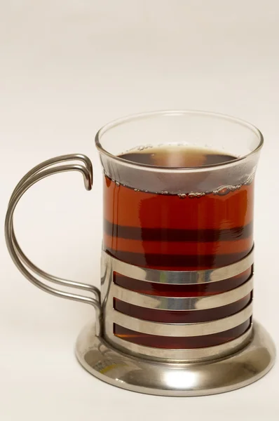 Glass of black tea with steel glass hold — Stock Photo, Image