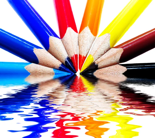 Colored pencils on water — Stock Photo, Image