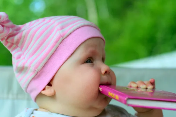 Baby eating book — Stock Photo, Image