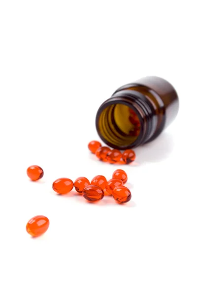 Frasco de vidrio con pastillas rojas — Foto de Stock