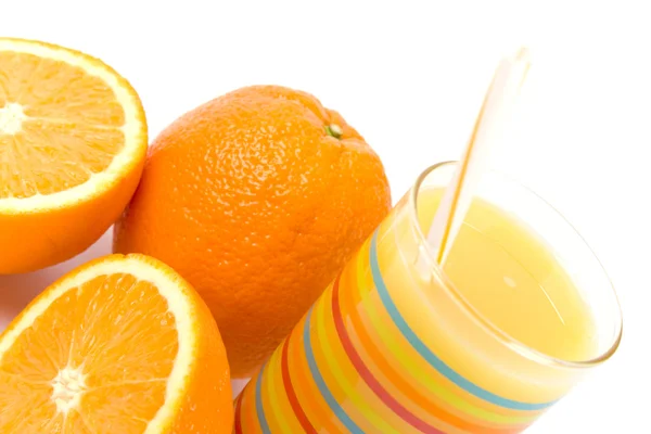 Glass of juice and oranges — Stock Photo, Image