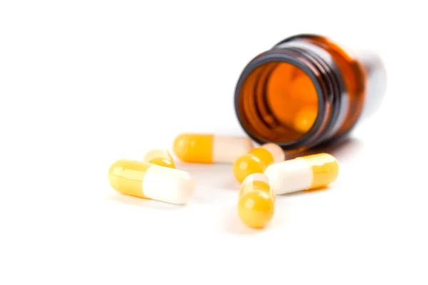 Bottle with yelllow capsules — Stock Photo, Image