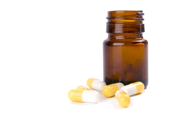 Bottle with yellow capsules — Stock Photo, Image