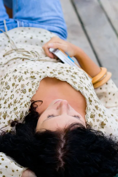 Woman lying with book — Stock Photo, Image