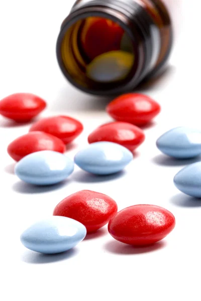 Frasco con píldoras rojas y azules —  Fotos de Stock