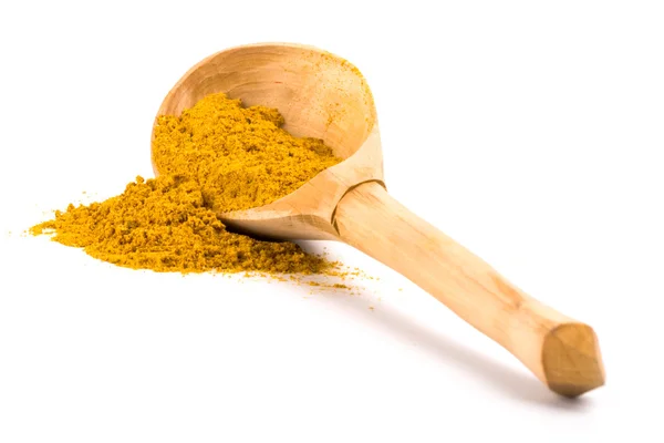 Yellow turmeric on wooden spoon — Stock Photo, Image